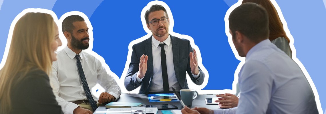 business meeting with man with blue tie speaking